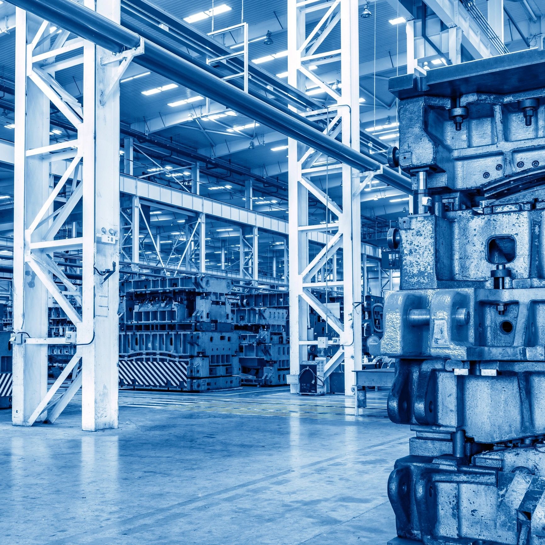 Modern industrial manufacturing facility interior with blue lighting